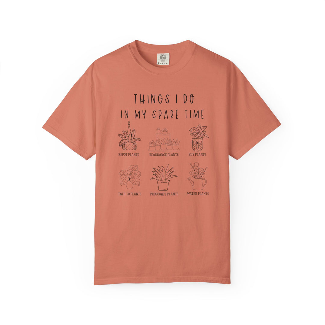 Plants Spare Time Tee features playful plant-themed graphics and captions, highlighting indoor gardening activities on a rust-colored shirt, perfect for plant enthusiasts.