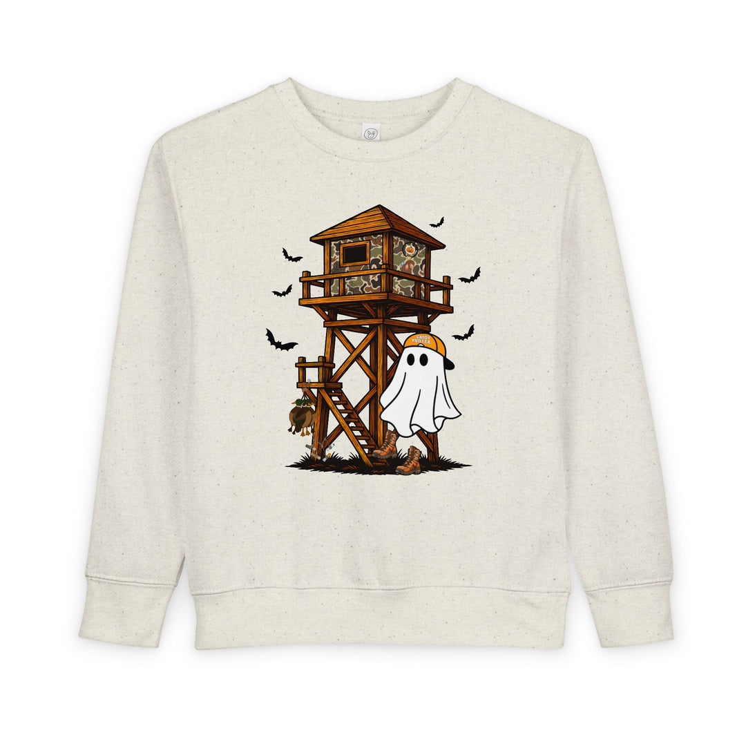 Ghost Hunter Toddler Crew sweatshirt featuring a playful Halloween hunting scene with a cartoon ghost in hiking boots and a Ghost Hunter cap near a deer-watch tower.