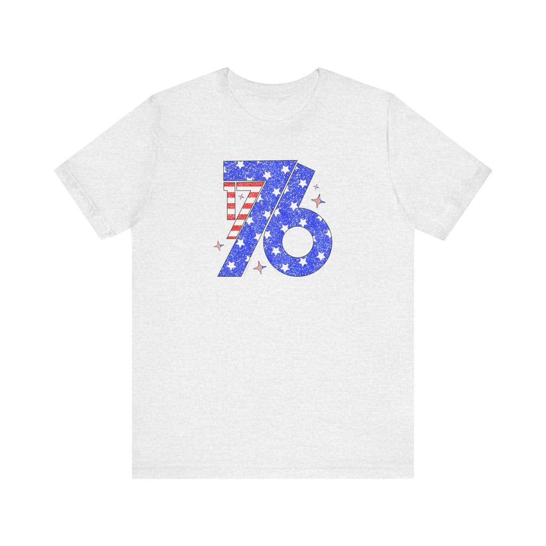A classic 1776 Tee: white shirt with red, blue, stars, and stripes design. Unisex jersey tee with ribbed knit collar, 100% cotton, retail fit. Sizes XS-3XL.