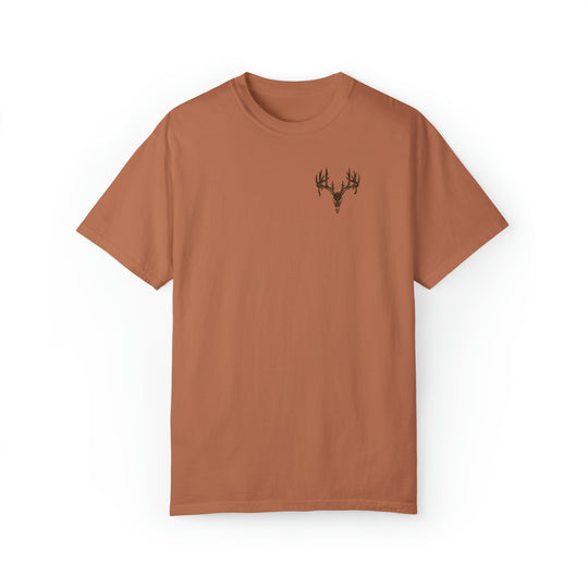 A brown t-shirt featuring a deer head design, part of the Tagged Out Tee collection by Worlds Worst Tees. Unisex, relaxed fit, 80% ring-spun cotton, 20% polyester fabric.