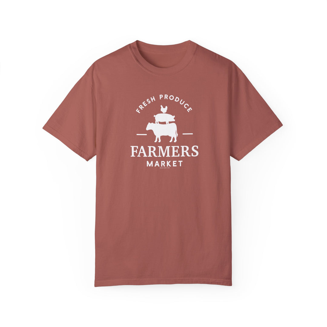 A relaxed-fit Farmers Market Tee in red with white text, crafted from 100% ring-spun cotton. Garment-dyed for extra coziness, featuring double-needle stitching for durability and a seamless design.