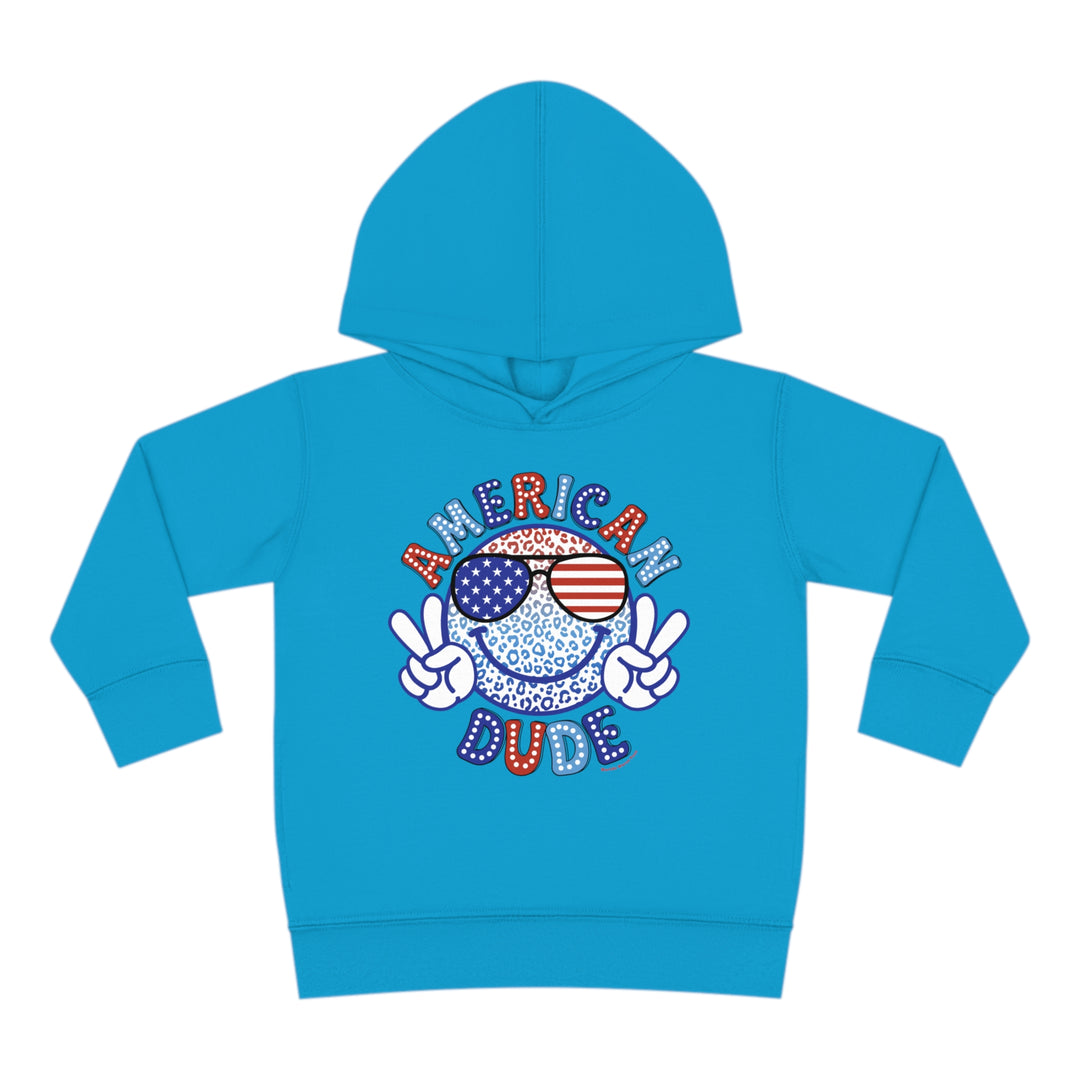 American Dude Toddler Hoodie featuring a cartoon character with a peace sign, sunglasses, and a smiley face design. Made of 60% cotton, 40% polyester for cozy durability. Designed with side seam pockets for added functionality.