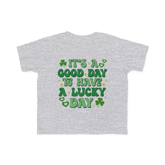 Good Day Lucky Day Toddler's Tee featuring green text and a clover design on a grey background, perfect for sensitive skin.