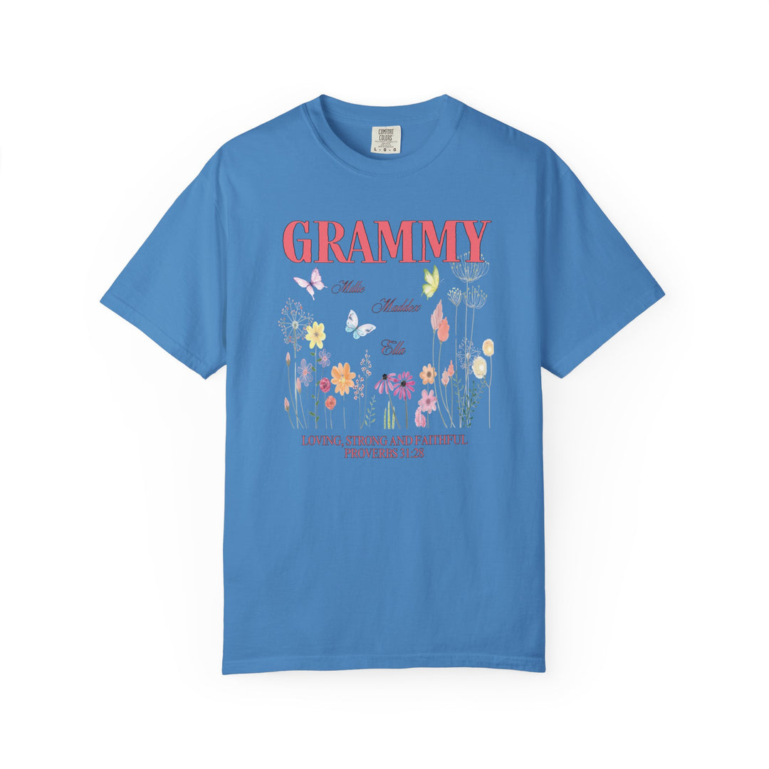 Grammy Tee: Blue shirt adorned with floral and butterfly designs, featuring a relaxed fit and durable double-needle stitching for everyday comfort.