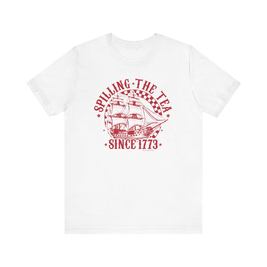 A classic white tee with red text and a sailboat logo, embodying the Spilling the Tea Since 1773 title. Unisex jersey tee made of soft cotton, featuring ribbed knit collars and taping on shoulders for a better fit.