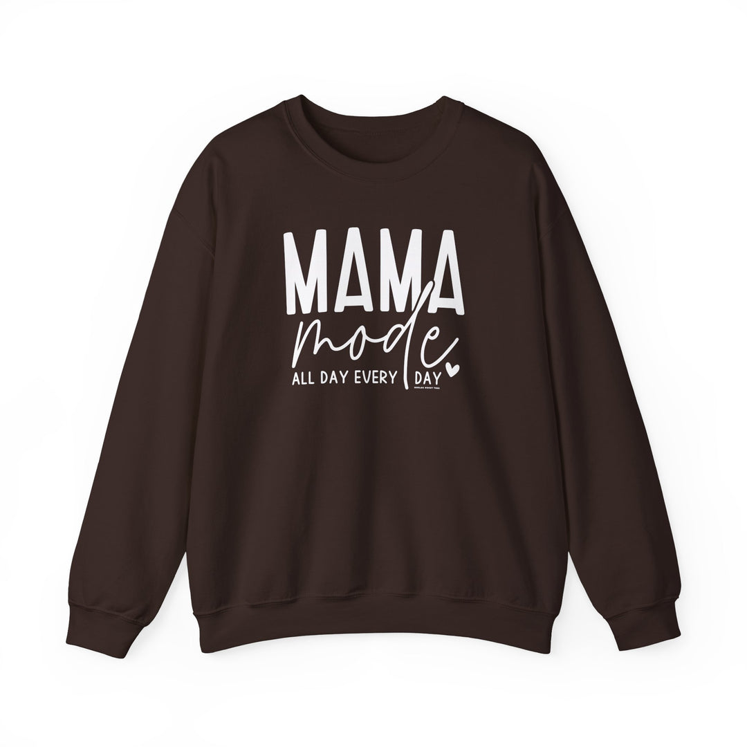A Mama Mode Crew unisex sweatshirt, featuring white text on brown fabric. Made of 50% cotton and 50% polyester, with ribbed knit collar and a loose fit. Ideal for comfort in a medium-heavy fabric.