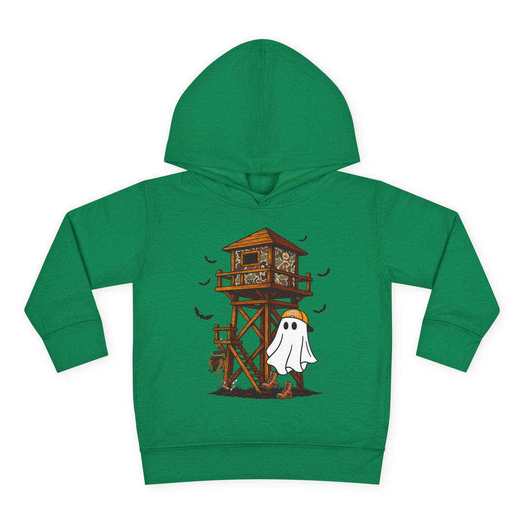 Ghost Hunter Toddler Hoodie: Green hoodie featuring a playful Halloween-hunting scene with a camo-patterned deer stand, bats, and a ghost in an orange cap and boots.