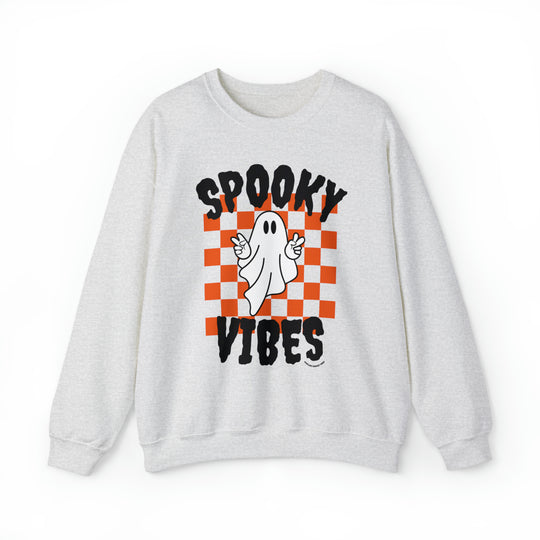 A white crewneck sweatshirt featuring a ghost design, embodying spooky vibes. Unisex heavy blend with ribbed knit collar, 50% cotton, 50% polyester, loose fit, and sewn-in label. Ideal for comfort in any situation.