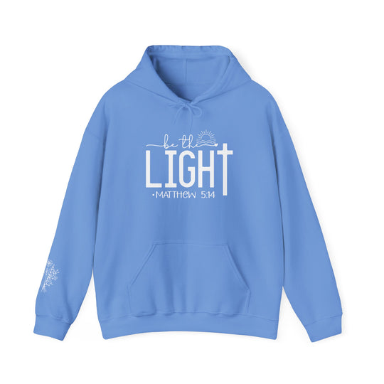 A cozy unisex Be the Light Hoodie in blue with white text. Made of cotton and polyester, featuring a kangaroo pocket and matching drawstring. Perfect for chilly days.