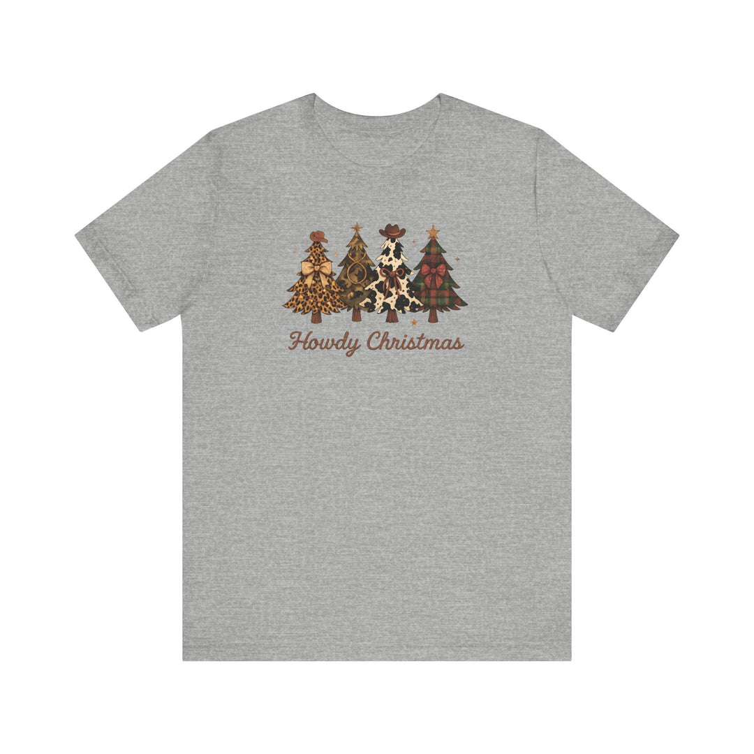 Howdy Christmas Tee features four Christmas trees with Western-themed designs and cowboy hats, paired with Howdy Christmas in brown script on a heather-gray T-shirt.