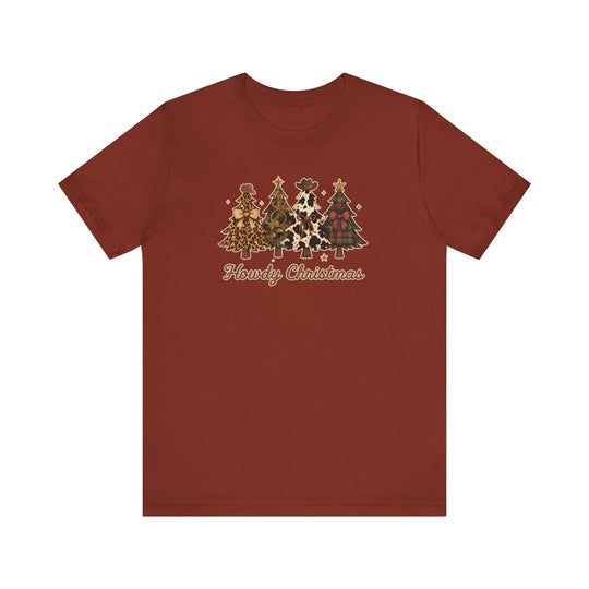 Rust-red Howdy Christmas Tee featuring Western-themed trees with unique patterns and cowboy accents, crafted from soft cotton for a comfortable, lasting fit.