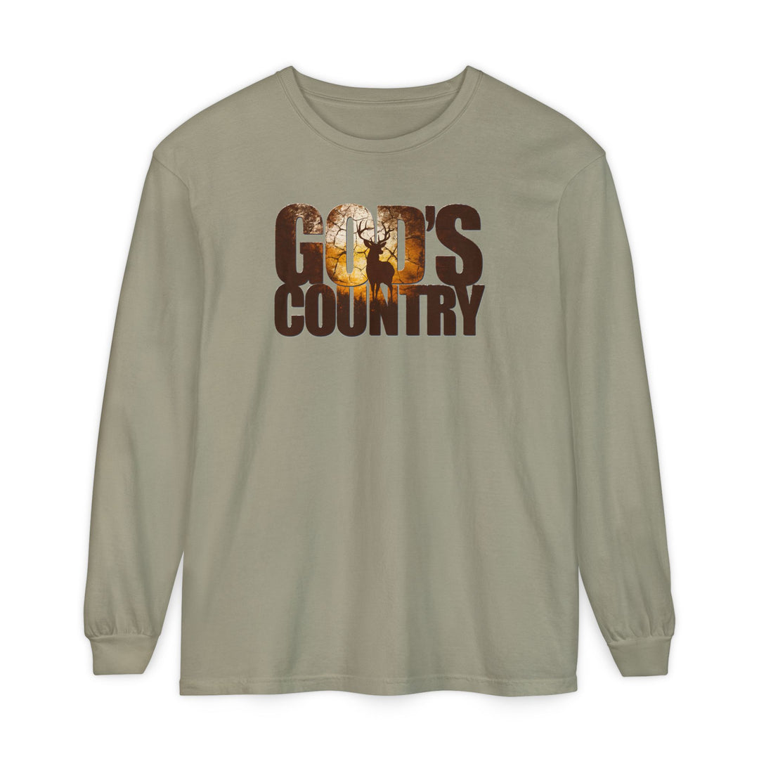 God's Country Long Sleeve Tee features earth-tone design with GOD'S COUNTRY and a deer silhouette in a woodland sunset scene, made from soft, 100% ring-spun cotton.
