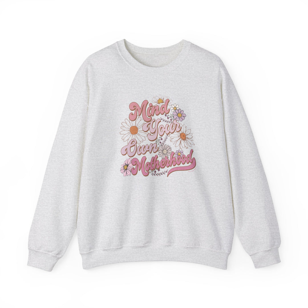 Unisex Mind Your Own Motherhood Crew sweatshirt, white with pink floral and text details. Heavy blend fabric, ribbed knit collar, no itchy seams. Sizes S-5XL. Ideal comfort for any occasion.