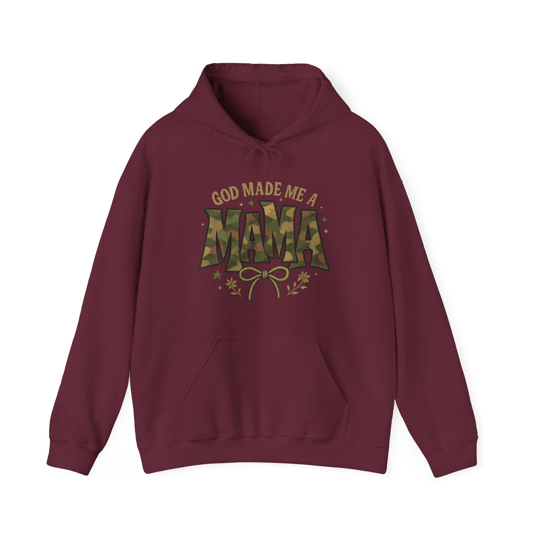 God Made Me a Mama Hoodie with camouflage MAMA, stars, floral sprigs, and bow graphic. Features a kangaroo pocket, color-matched drawstring, and double-lined hood.