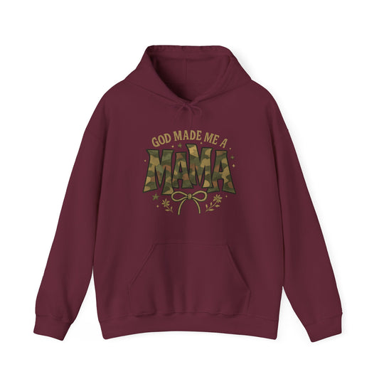 God Made Me a Mama Hoodie with camouflage MAMA, stars, floral sprigs, and bow graphic. Features a kangaroo pocket, color-matched drawstring, and double-lined hood.