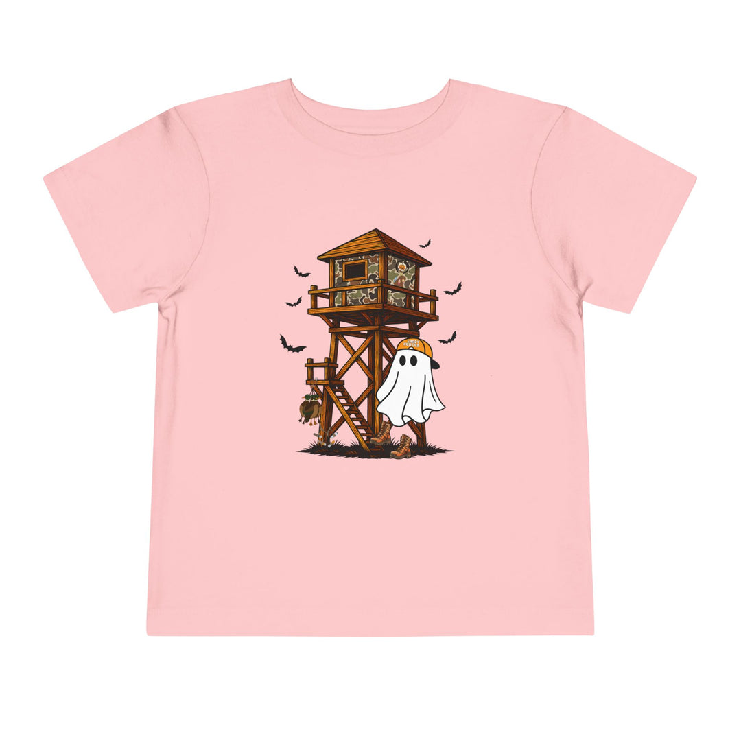 Ghost Hunter Toddler Tee featuring a cartoon ghost in a hunting cap, bats, and deer skull, all on a light-pink background. Perfect for a playful, spooky look.