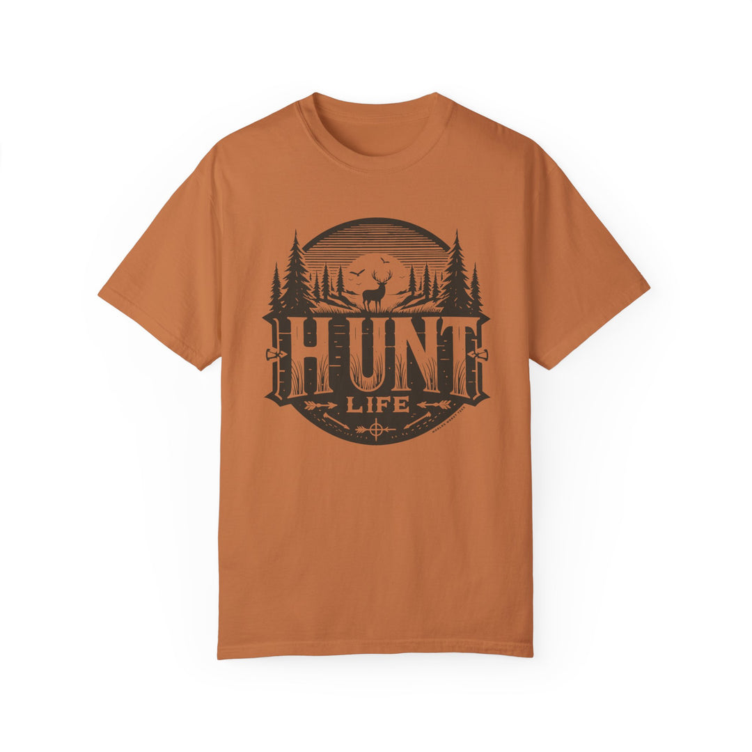 A brown Hunt Life Tee, featuring a logo, made of 100% ring-spun cotton. Relaxed fit, double-needle stitching for durability, and seamless design for a tubular shape. Ideal for daily wear.