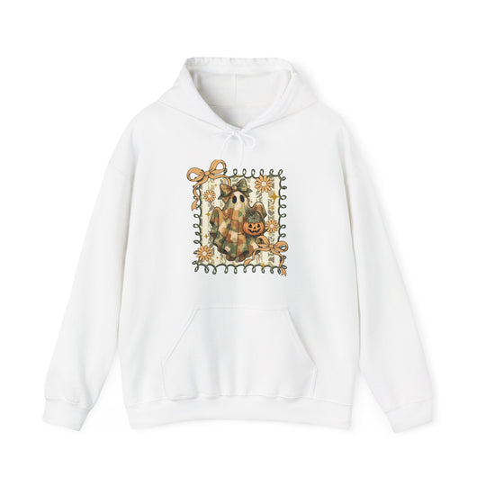 Quilted Ghost Hoodie features a camo-patterned ghost with a bow, holding a jack-o’-lantern, surrounded by vine and floral accents on a white pullover.