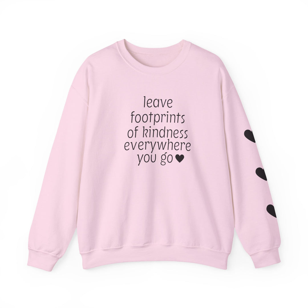 Light pink crewneck sweatshirt with leave footprints of kindness everywhere you go ♥ on front, three black hearts on right sleeve.