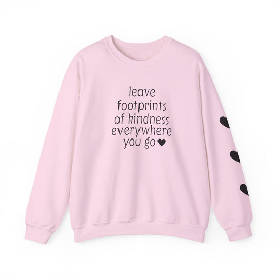 Light pink crewneck sweatshirt with leave footprints of kindness everywhere you go ♥ on front, three black hearts on right sleeve.