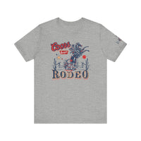 Coors Rodeo Tee: A grey t-shirt featuring red and blue text and a graphic design. Unisex jersey tee with ribbed knit collars, taping on shoulders, and 100% Airlume combed cotton for a comfortable fit.