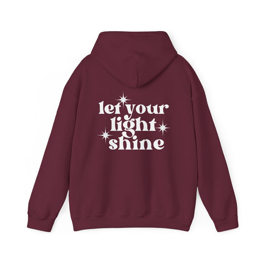 Unisex Let Your Light Shine Hoodie, red with white text and star details, a cozy blend of cotton and polyester, featuring a kangaroo pocket and matching hood drawstring. Classic fit, medium-heavy fabric.