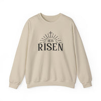 A comfortable unisex heavy blend crewneck sweatshirt, the He is Risen Crew, in white with black text. Made from 50% cotton and 50% polyester, featuring ribbed knit collar and durable double-needle stitching.
