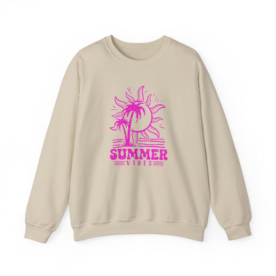 A beige crewneck sweatshirt featuring a pink sun and palm tree design, embodying summer vibes. Unisex heavy blend fabric for comfort, ribbed knit collar, and no itchy side seams. Ideal for casual wear.