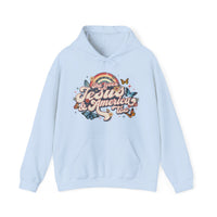 A light blue She Loves Jesus and America hoodie with a graphic design of butterflies and flowers. Unisex heavy blend hooded sweatshirt made of 50% cotton and 50% polyester, featuring a kangaroo pocket and drawstring hood.