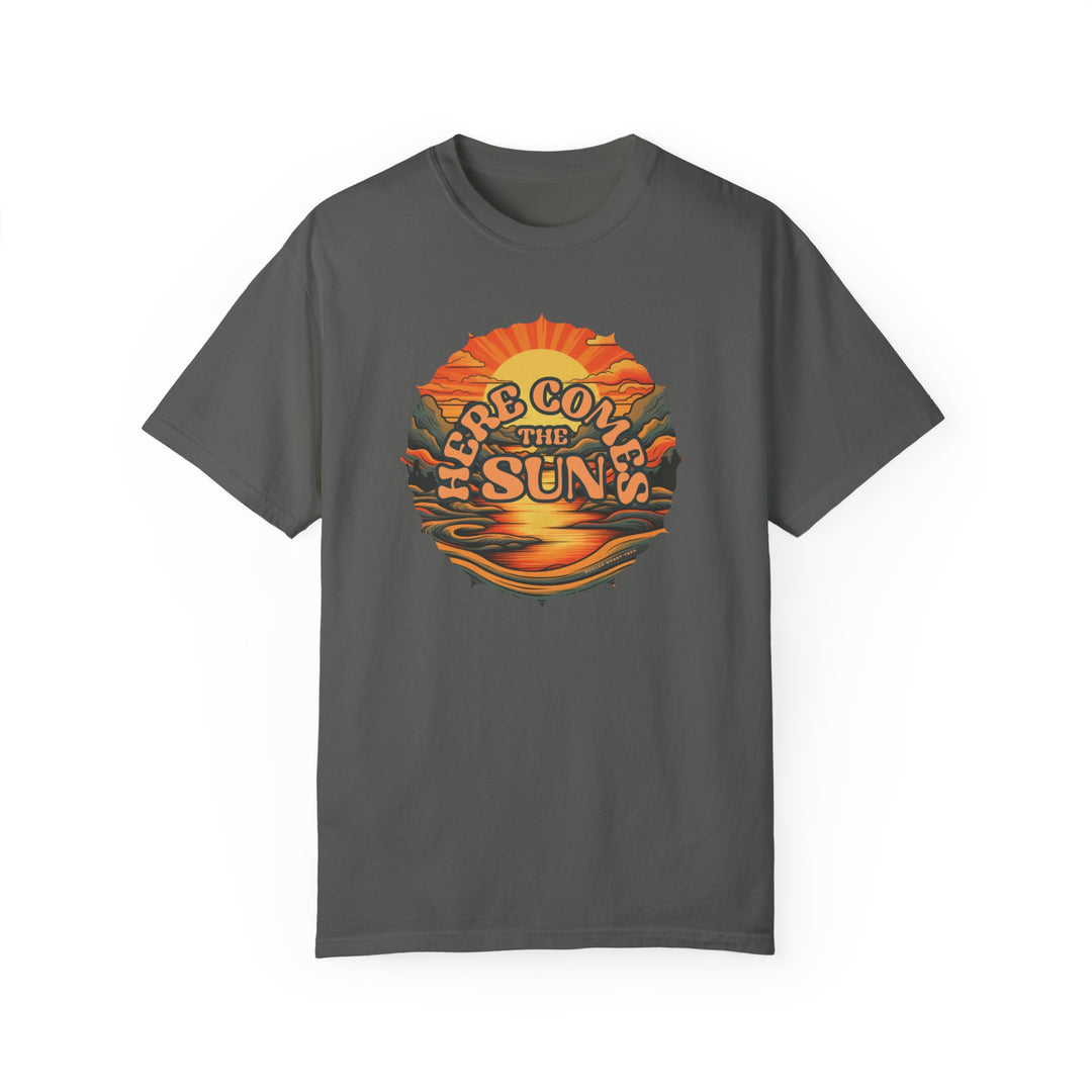 A relaxed fit Here Comes The Sun Tee, grey with a mountain sunset graphic. 100% ring-spun cotton, soft-washed, durable double-needle stitching, no side-seams for tubular shape retention. Sizes S to 3XL.