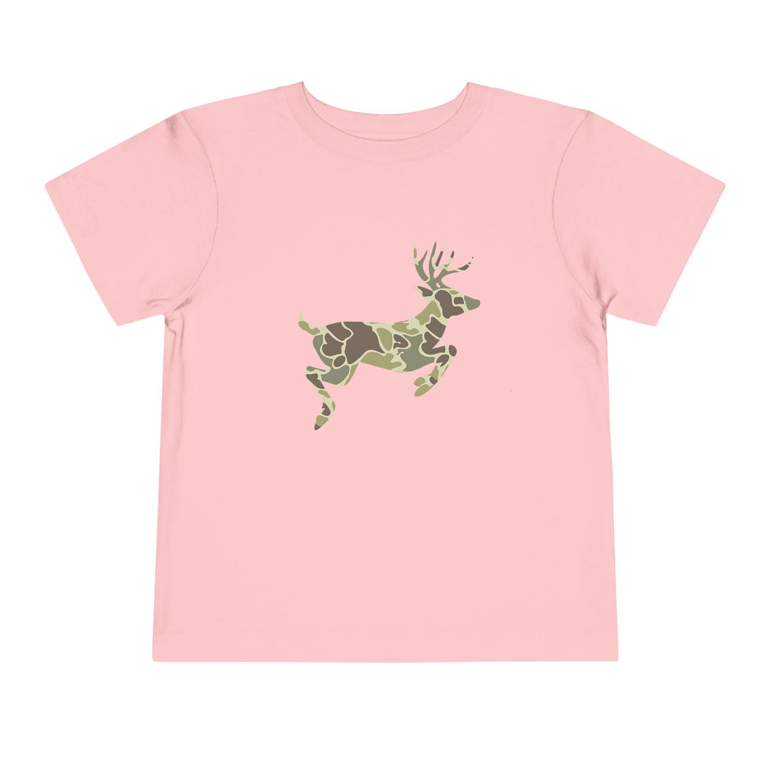 Camo Deer Toddler Tee: Light pink short-sleeve shirt featuring a leaping deer with a green/brown camouflage pattern, made from soft Airlume cotton for toddler comfort.