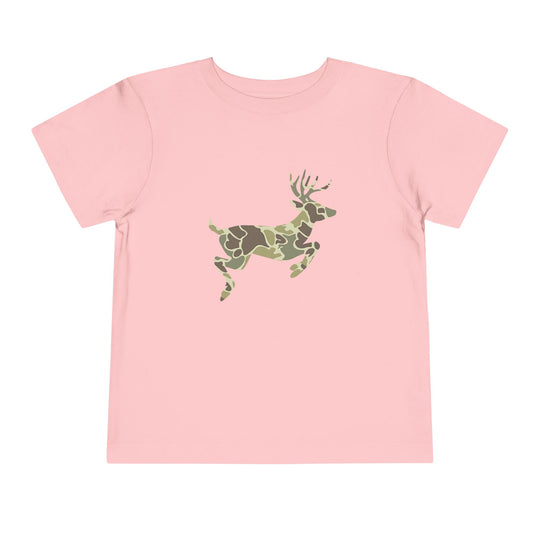 Camo Deer Toddler Tee: Light pink short-sleeve shirt featuring a leaping deer with a green/brown camouflage pattern, made from soft Airlume cotton for toddler comfort.