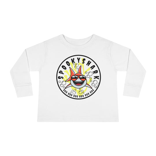 Spooky Shark Toddler Long Sleeve Tee featuring a cartoon shark with sunglasses on a white shirt. Made of 100% combed ringspun cotton, with ribbed collar and EasyTear™ label for comfort and durability.