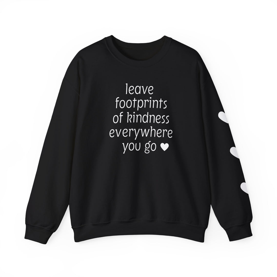 Black crewneck sweatshirt with leave footprints of kindness everywhere you go ♥ slogan and white hearts on sleeve, emphasizing comfort and ethical production.
