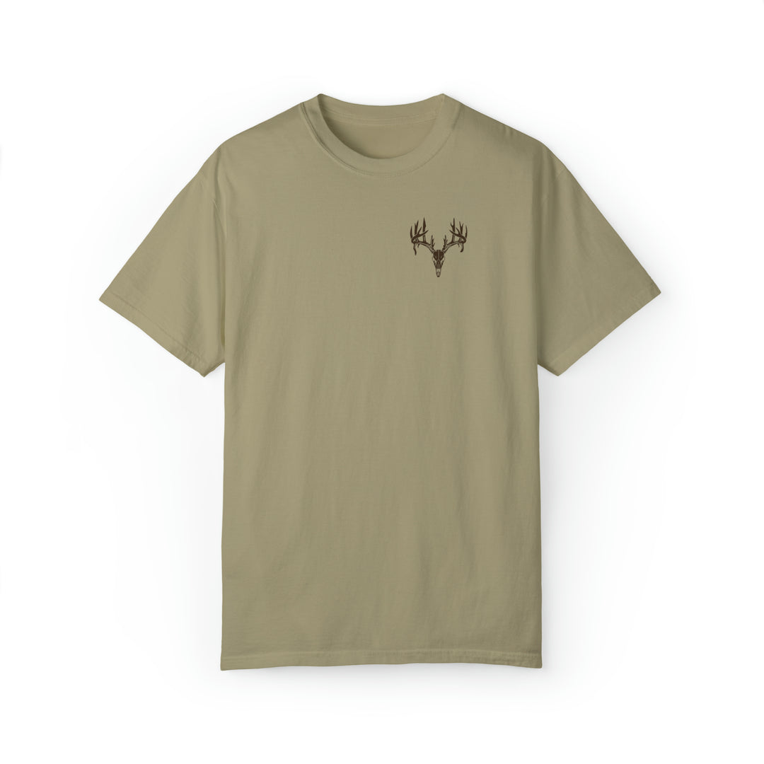 A tan t-shirt featuring a deer skull design, crafted with 80% ring-spun cotton and 20% polyester. Unisex, relaxed fit with rolled-forward shoulders for comfort. From Worlds Worst Tees, known for unique graphic t-shirts.