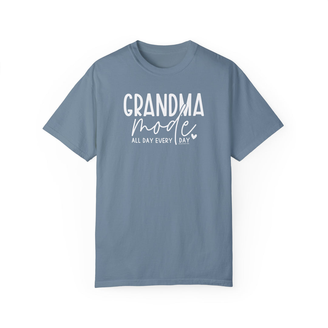 Grandma Mode Tee: A relaxed-fit, garment-dyed t-shirt in blue with white text. 100% ring-spun cotton for coziness, double-needle stitching for durability, and seamless design for a tubular shape. From Worlds Worst Tees.