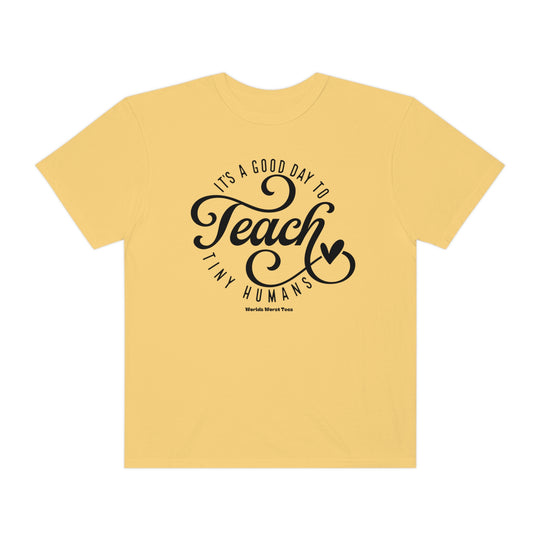 Unisex Teach Tiny Humans Tee, a yellow t-shirt with black text. Made of 80% ring-spun cotton and 20% polyester, featuring a relaxed fit and rolled-forward shoulder for comfort.