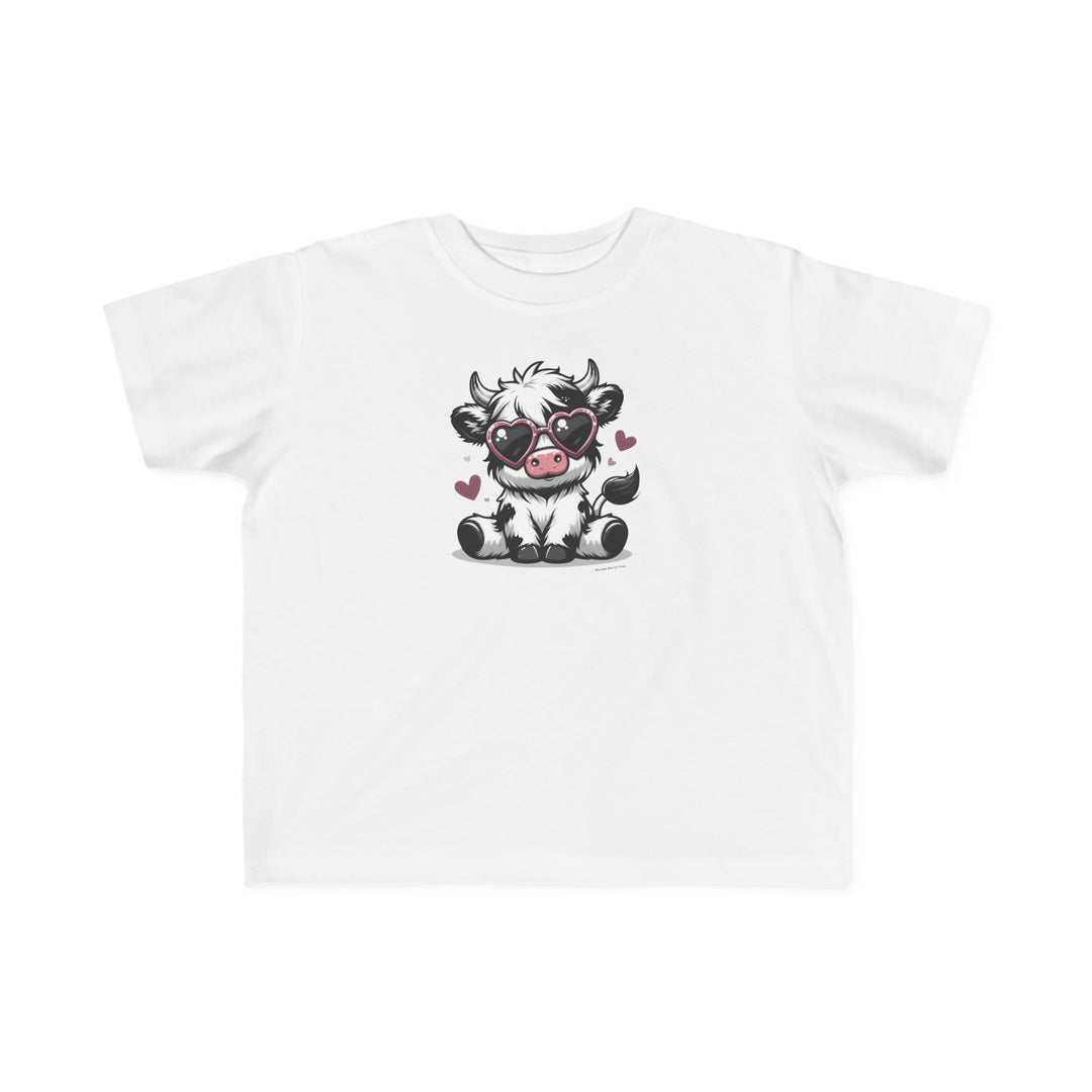 Cute Cow Toddler Tee: A white t-shirt featuring a cartoon cow in heart-shaped sunglasses, perfect for sensitive skin. 100% combed ringspun cotton, light fabric, tear-away label, classic fit. Sizes: 2T, 3T, 4T, 5-6T.