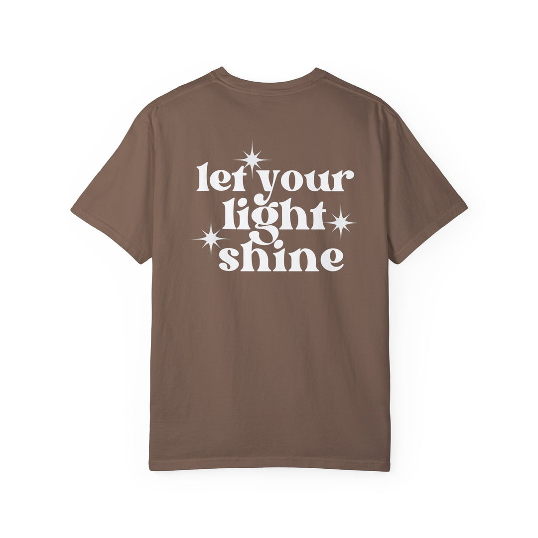 Relaxed fit Let Your Light Shine Tee, a brown shirt with white text. 100% ring-spun cotton, garment-dyed for coziness. Durable double-needle stitching, no side-seams for a tubular shape.