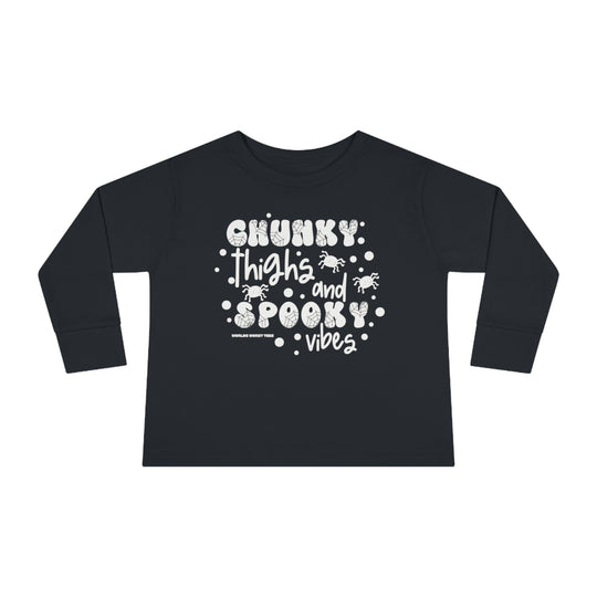 Chunky Thighs and Spooky Vibes Toddler Long Sleeve Tee, featuring black shirt with white text, spiders, and dots. Made of durable 100% combed ringspun cotton, with ribbed collar and EasyTear™ label for comfort.