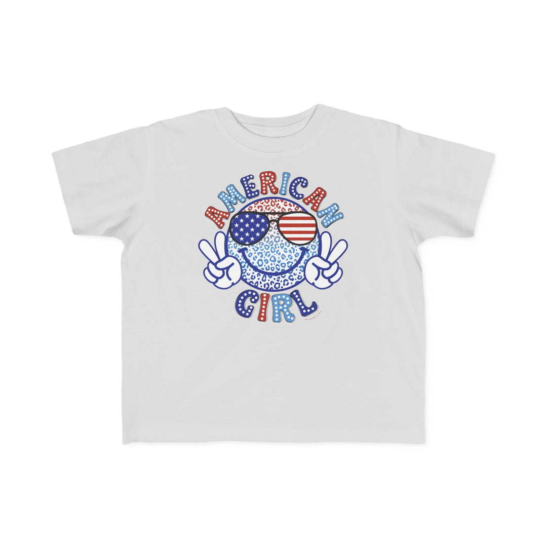 American Girl Toddler Tee featuring a cartoon face with sunglasses and a peace sign. Soft 100% combed ringspun cotton, light fabric, classic fit. Sizes: 2T, 3T, 4T, 5-6T.