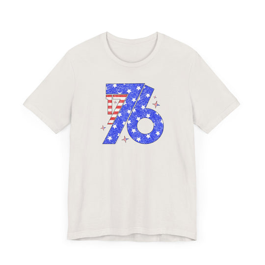 A classic 1776 Tee: white shirt with blue and red design, stars, and stripes. Unisex jersey tee, 100% cotton, light fabric, retail fit, tear away label. Sizes XS-3XL.