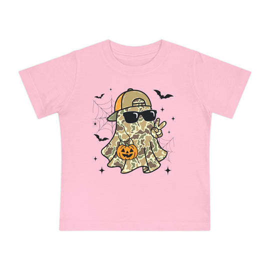 Candy Ghost Baby Tee: Light-pink children’s T-shirt featuring a camo-clad ghost with sunglasses, peace sign, and jack-o’-lantern, surrounded by bats and spiderwebs.