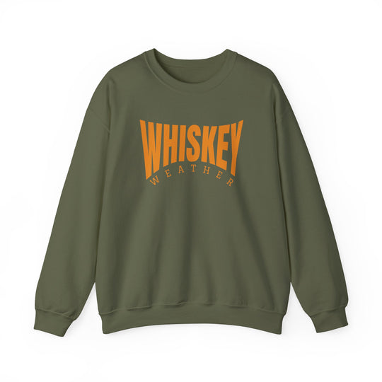 Olive-green crewneck sweatshirt featuring bold orange WHISKEY WEATHER text across the chest; unisex, cozy fit with ribbed cuffs and waistband.