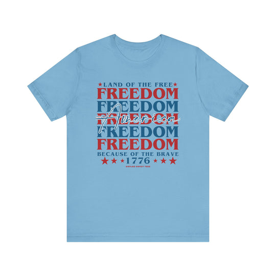 Unisex American Freedom Tee: Classic blue shirt with red and white text. Soft cotton, ribbed knit collars, and taping for better fit. Retail fit, 100% Airlume combed cotton. Sizes XS-3XL.