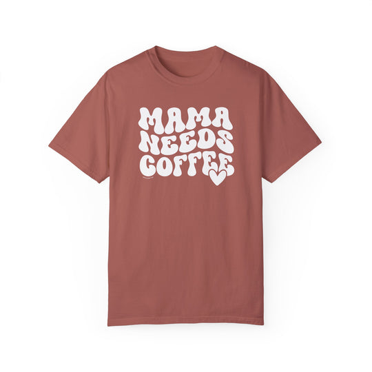A relaxed fit Mama Needs Coffee Tee in red with white text. 100% ring-spun cotton, garment-dyed for coziness. Double-needle stitching for durability, no side-seams for shape retention.