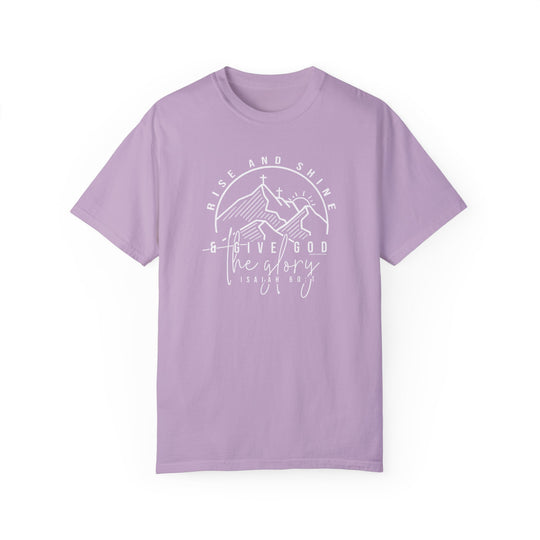 A relaxed fit Rise and Shine Tee in purple with white text, featuring a cross and mountains design. Made of 100% ring-spun cotton for comfort and durability, perfect for daily wear.