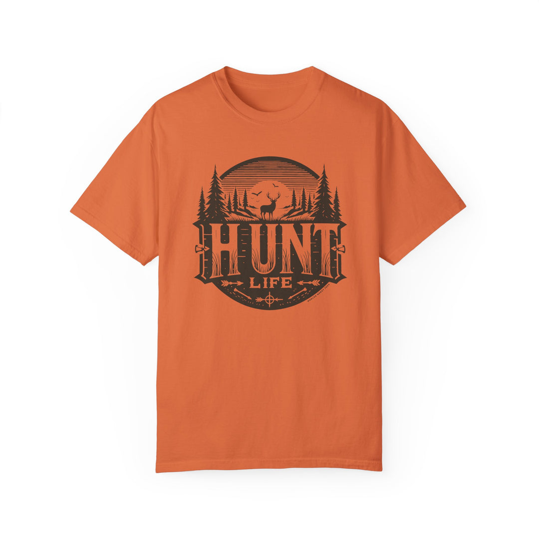 An orange Hunt Life Tee, featuring a deer and birds silhouette graphic on ring-spun cotton. Medium weight, relaxed fit, durable double-needle stitching, and seamless design for comfort and style.