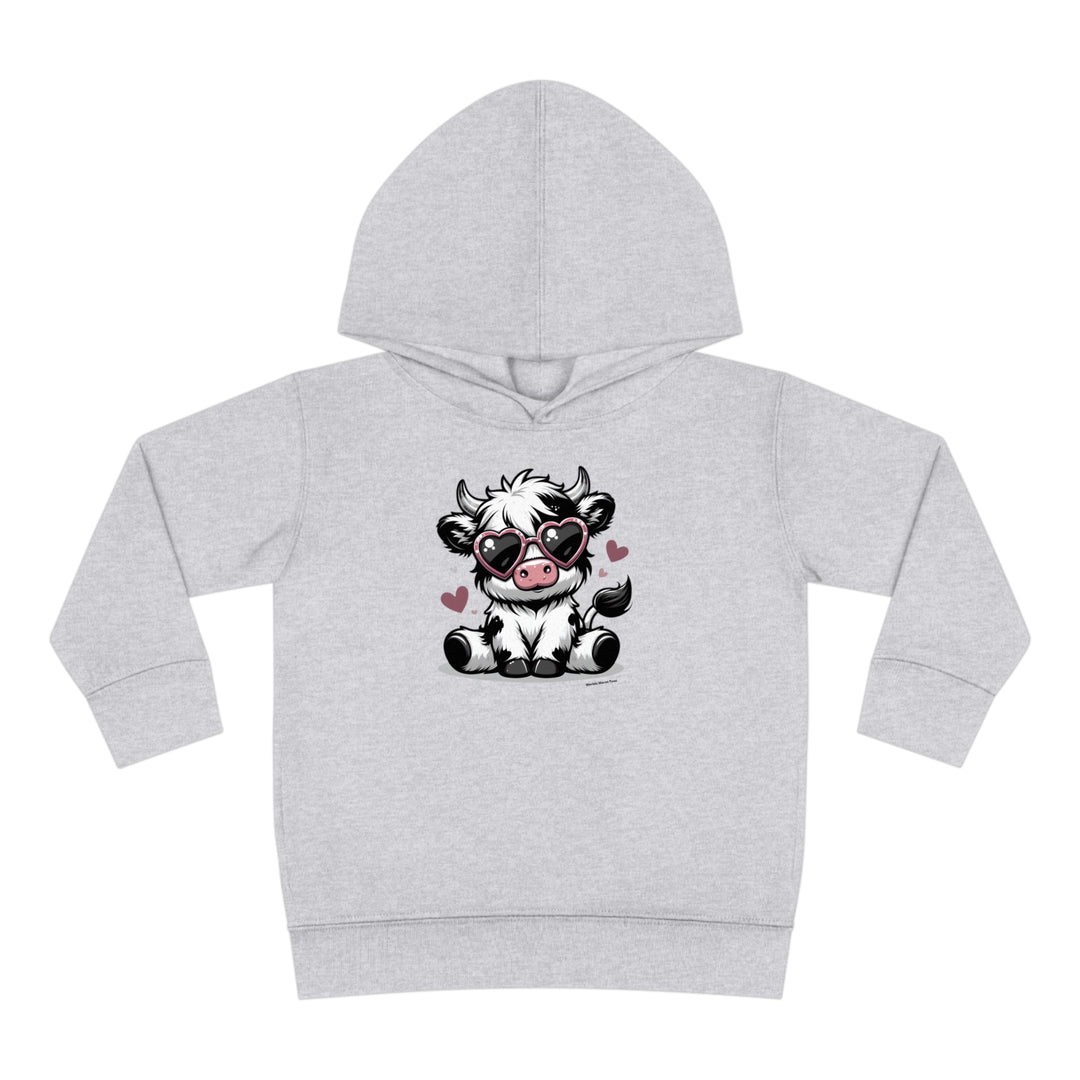 Toddler hoodie featuring a cartoon cow with sunglasses, designed for comfort and durability. Jersey-lined hood, cover-stitched details, and side seam pockets for coziness. Cute Cow Toddler Hoodie by Worlds Worst Tees.
