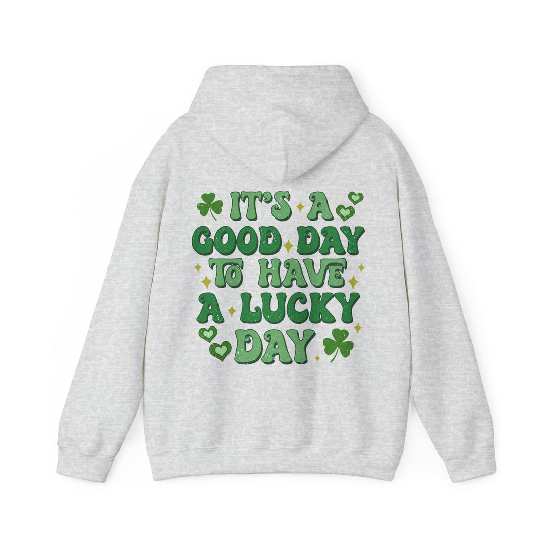 Good Day Lucky Day Hoodie features green text on a white sweatshirt, with a kangaroo pocket and drawstring hood, offering comfort and style.